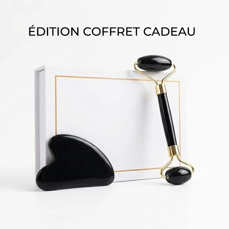 Édition coffret cadeau : rouleau et Gua Sha en obsidienne noire devant leur boîte blanche
